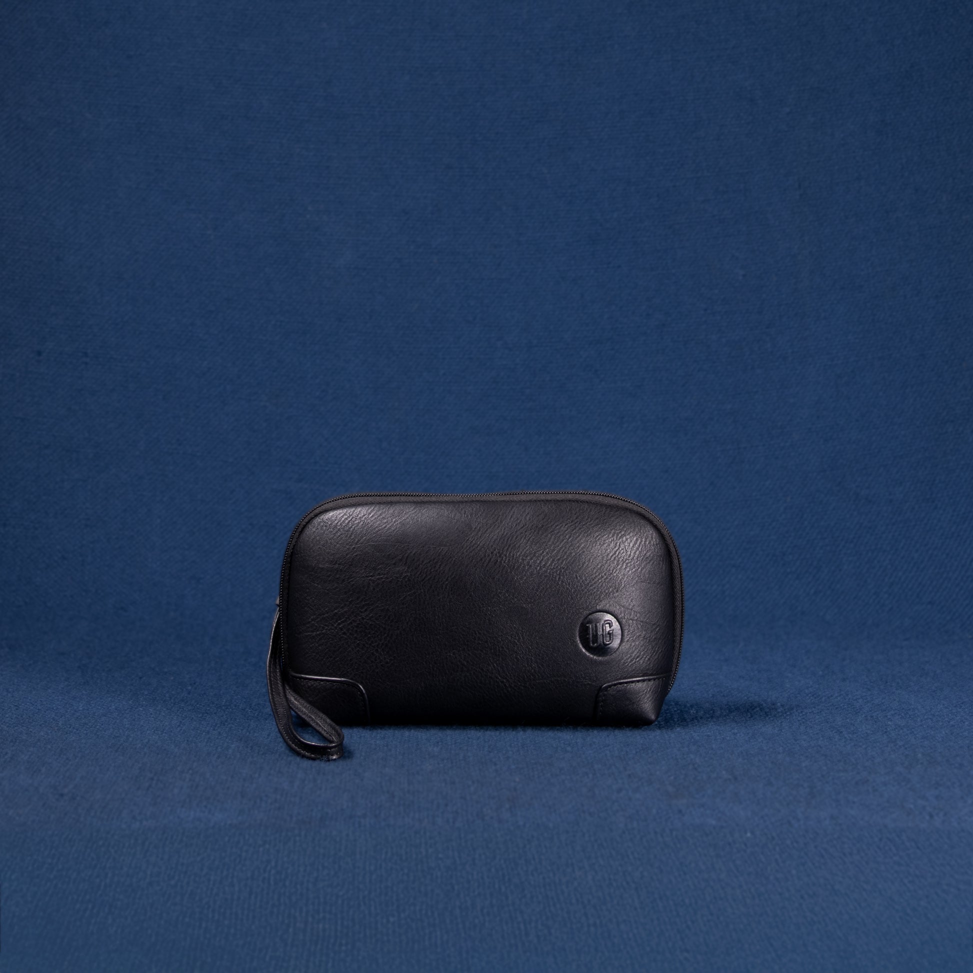 Nomad Pouch schwarz – flach liegend, Vorderseite mit markanter Struktur